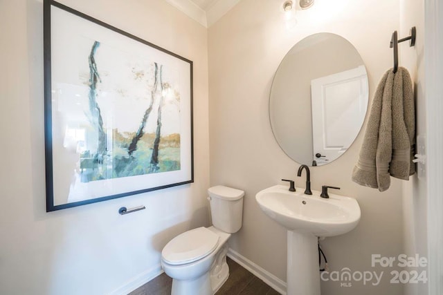 bathroom with hardwood / wood-style floors, toilet, and ornamental molding