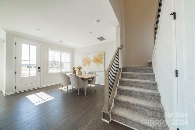 stairs with hardwood / wood-style flooring and ornamental molding