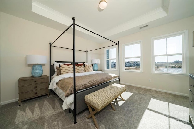 bedroom with carpet, crown molding, and a tray ceiling