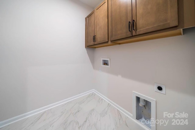 laundry room featuring electric dryer hookup, cabinets, and washer hookup