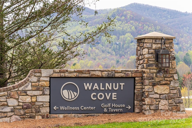 community sign with a mountain view