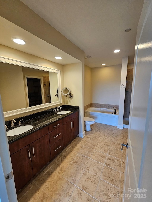 bathroom featuring vanity, tile patterned flooring, and a bathtub