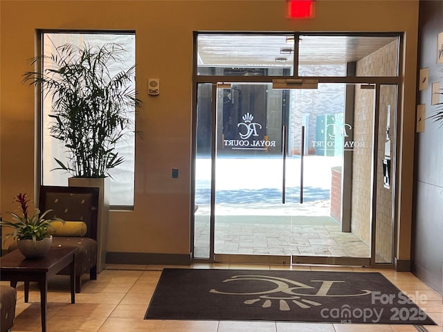 entryway with light tile patterned flooring