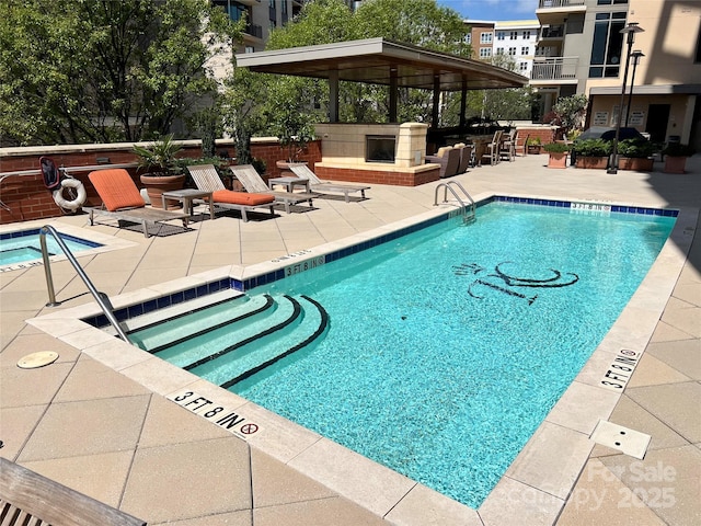 view of swimming pool featuring a gazebo, a patio, and a bar