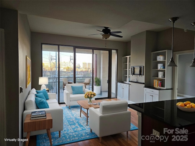 living room with hardwood / wood-style flooring and ceiling fan