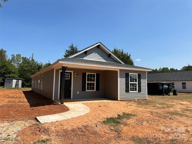 view of front of house featuring a storage unit