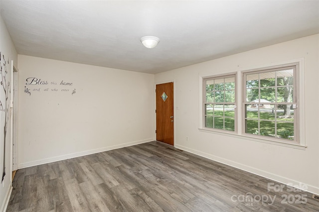 spare room with dark hardwood / wood-style flooring