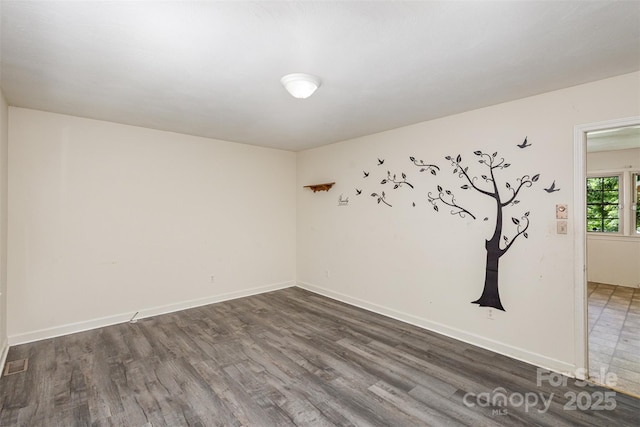 spare room featuring dark hardwood / wood-style floors