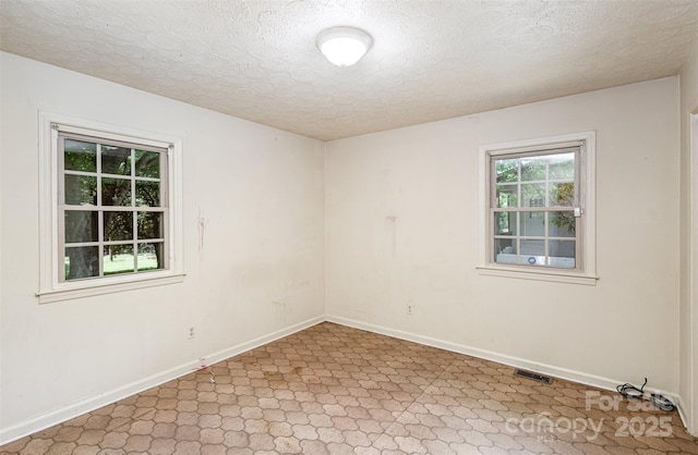 spare room featuring a textured ceiling