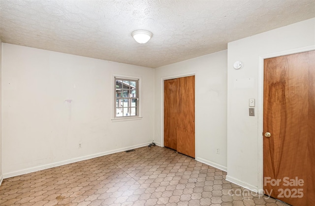 empty room featuring a textured ceiling