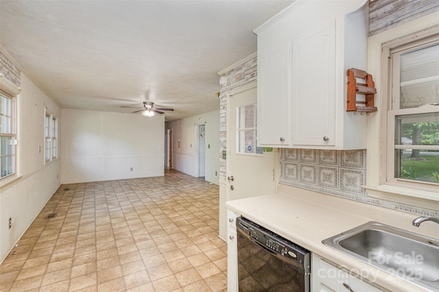 kitchen with sink, ceiling fan, decorative backsplash, black dishwasher, and white cabinetry