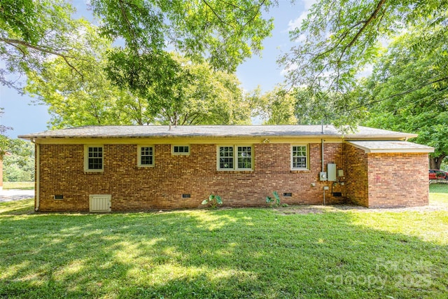 rear view of property with a lawn