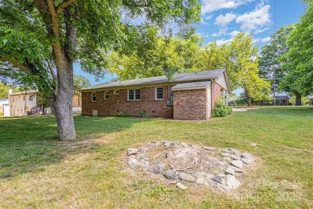 rear view of property featuring a yard