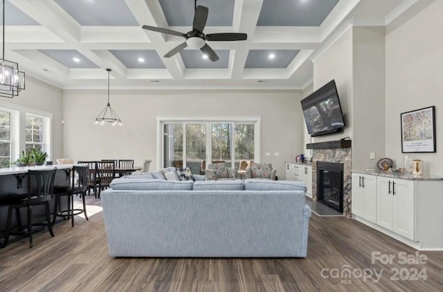 living room with dark wood-type flooring and coffered ceiling