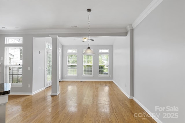 interior space with ornate columns, light hardwood / wood-style flooring, and ornamental molding