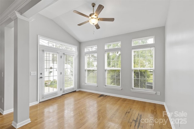 unfurnished sunroom with ceiling fan and vaulted ceiling