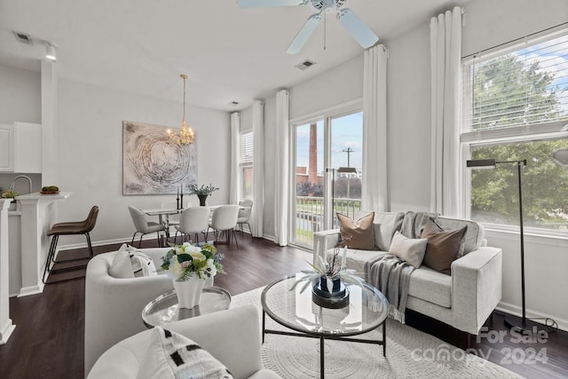 living room featuring ceiling fan and dark hardwood / wood-style flooring