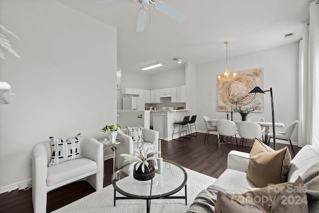 living room featuring ceiling fan with notable chandelier and hardwood / wood-style floors