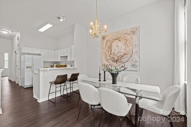 dining space with a notable chandelier and dark hardwood / wood-style floors