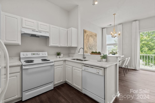 kitchen featuring white appliances, dark hardwood / wood-style flooring, white cabinetry, sink, and kitchen peninsula