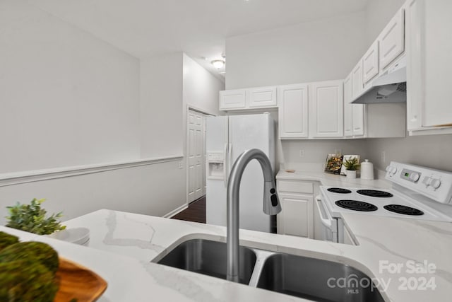 kitchen with custom exhaust hood, white cabinetry, light stone countertops, white range with electric cooktop, and dark hardwood / wood-style flooring