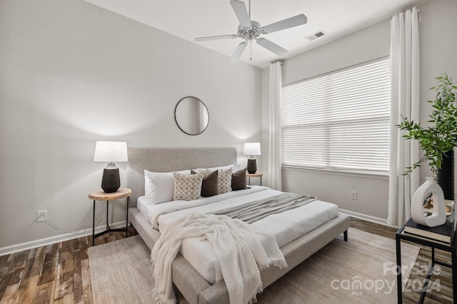 bedroom with ceiling fan and hardwood / wood-style flooring