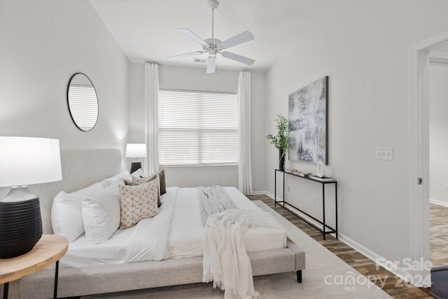 bedroom featuring ceiling fan and dark hardwood / wood-style flooring