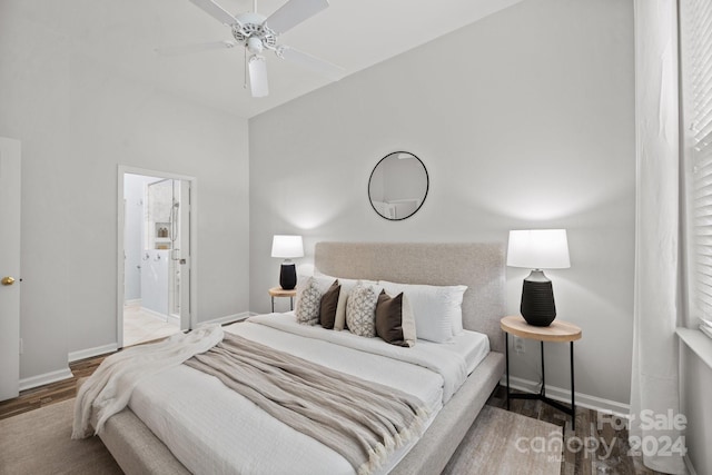 bedroom featuring hardwood / wood-style floors, ensuite bathroom, and ceiling fan