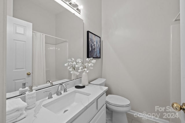 bathroom featuring vanity, toilet, and tile patterned flooring