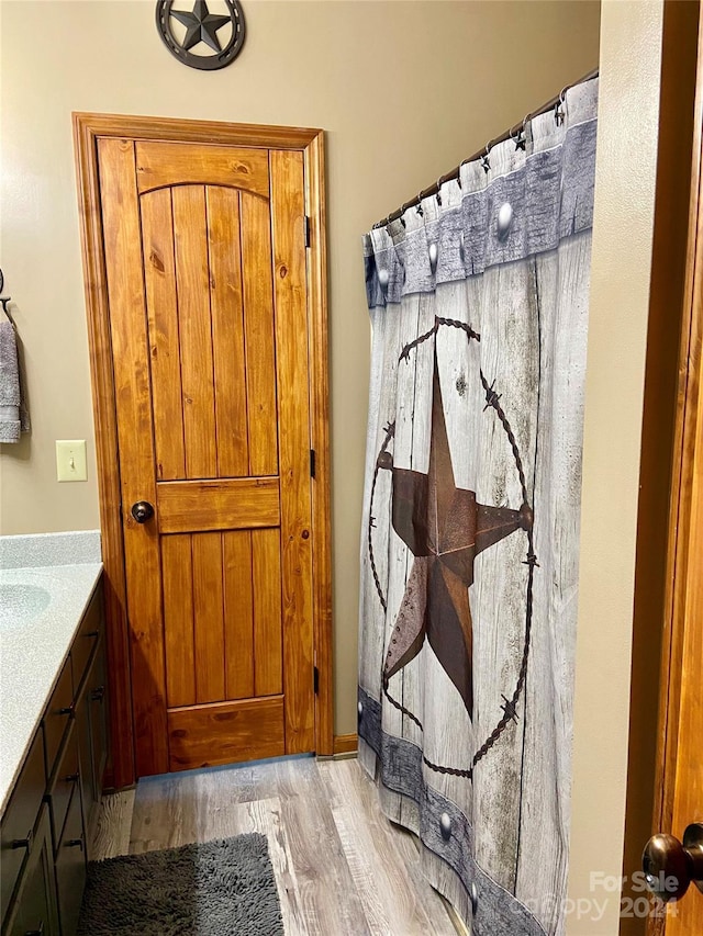 bathroom featuring vanity and wood-type flooring