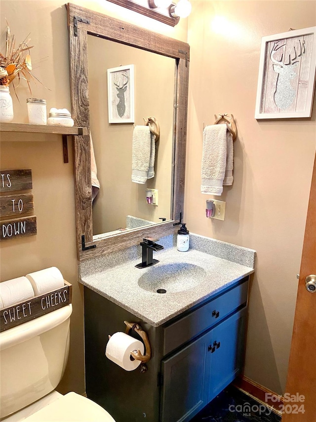 bathroom featuring vanity and toilet