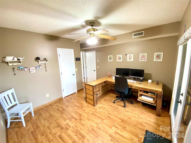 office area featuring ceiling fan, a textured ceiling, and light wood-type flooring