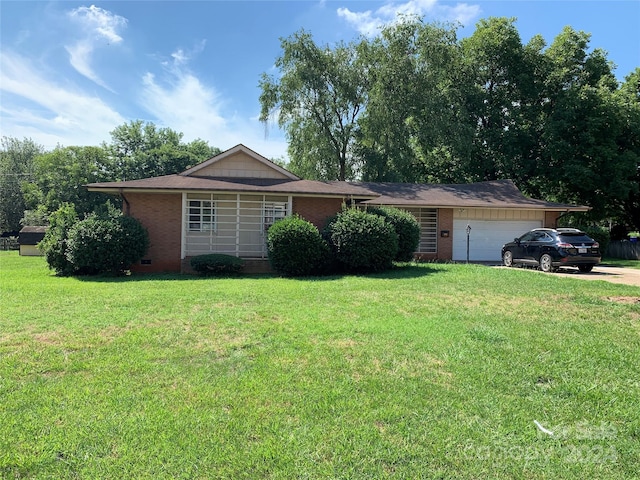 single story home with a garage and a front lawn