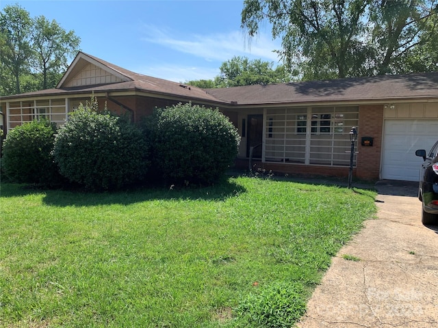 single story home with a front yard and a garage