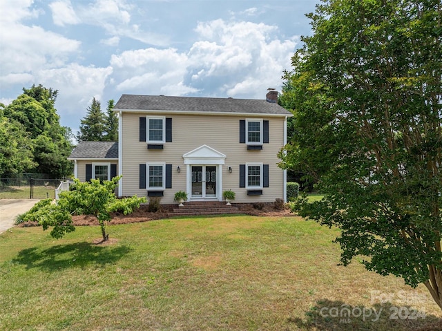 colonial inspired home with a front yard