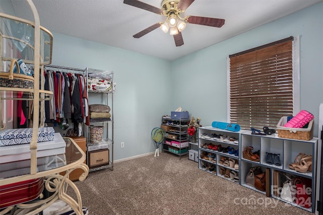 walk in closet featuring carpet floors and ceiling fan