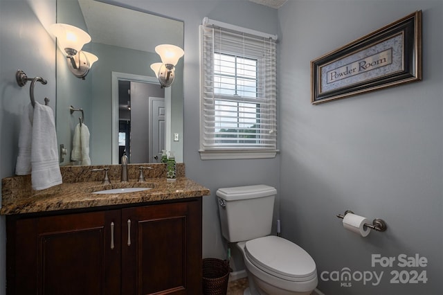 bathroom featuring toilet and vanity