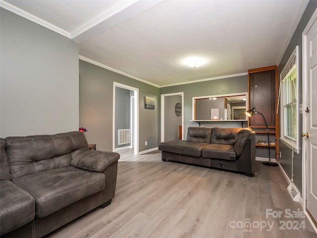 living room featuring crown molding and light hardwood / wood-style flooring