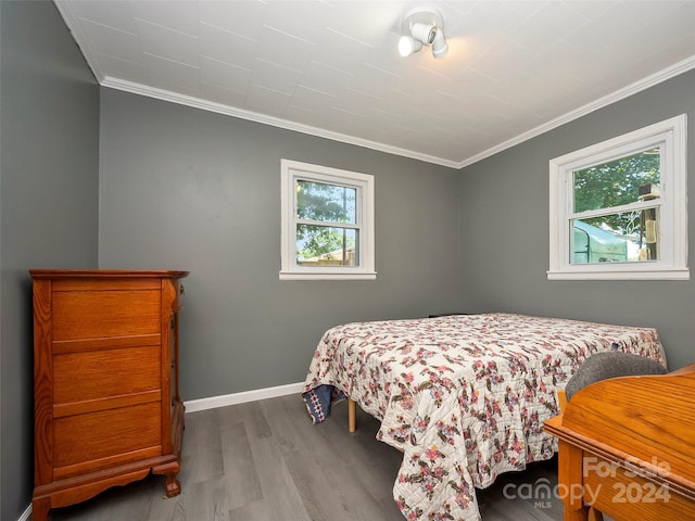 bedroom with wood-type flooring and crown molding