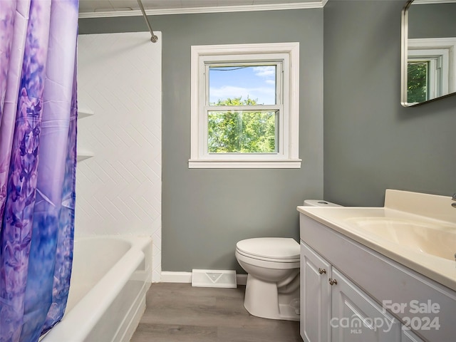 full bathroom featuring crown molding, wood-type flooring, shower / bath combination with curtain, toilet, and vanity