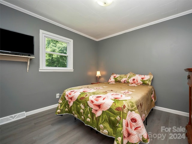 bedroom featuring ornamental molding and dark wood-type flooring