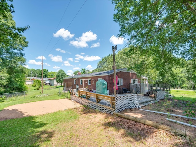 back of house with a yard and a deck