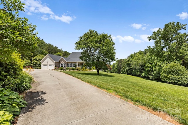 view of front facade with a front yard and a garage