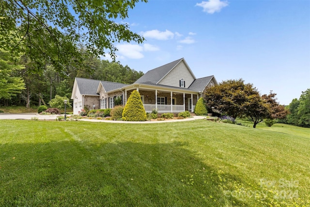 view of front of home featuring covered porch and a front yard