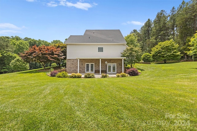 back of house with a yard and french doors