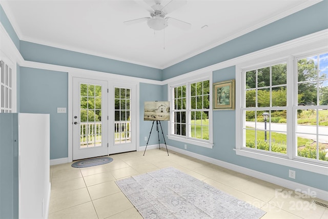 doorway to outside with ceiling fan, light tile patterned flooring, and crown molding