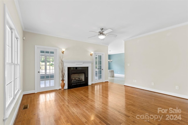 unfurnished living room with ceiling fan, ornamental molding, french doors, and light hardwood / wood-style flooring