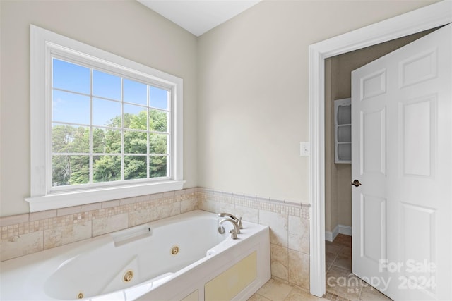 bathroom with tile patterned floors and a tub