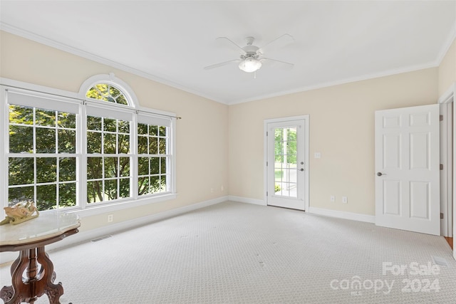 spare room featuring light carpet, ceiling fan, and a healthy amount of sunlight