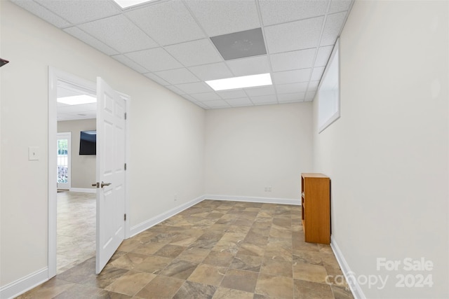 unfurnished room with a drop ceiling